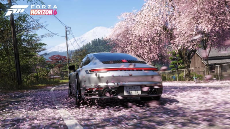 A sports car on a cherry-blossom-lined road in Forza Horizon 6