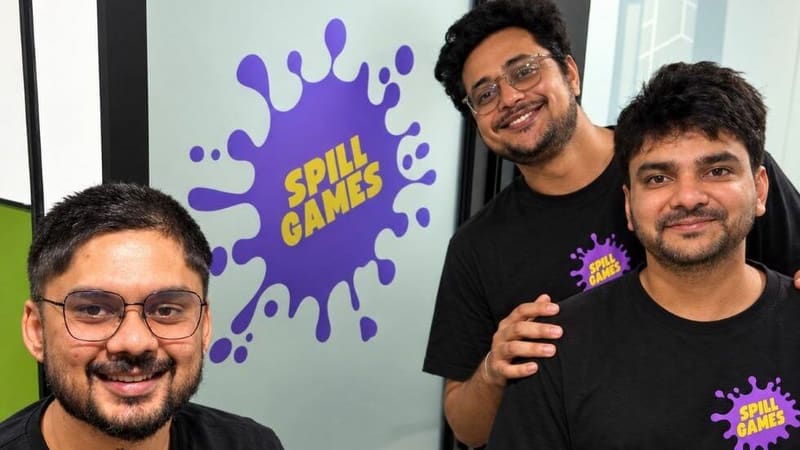 Spill Games founders in front of the studio logo